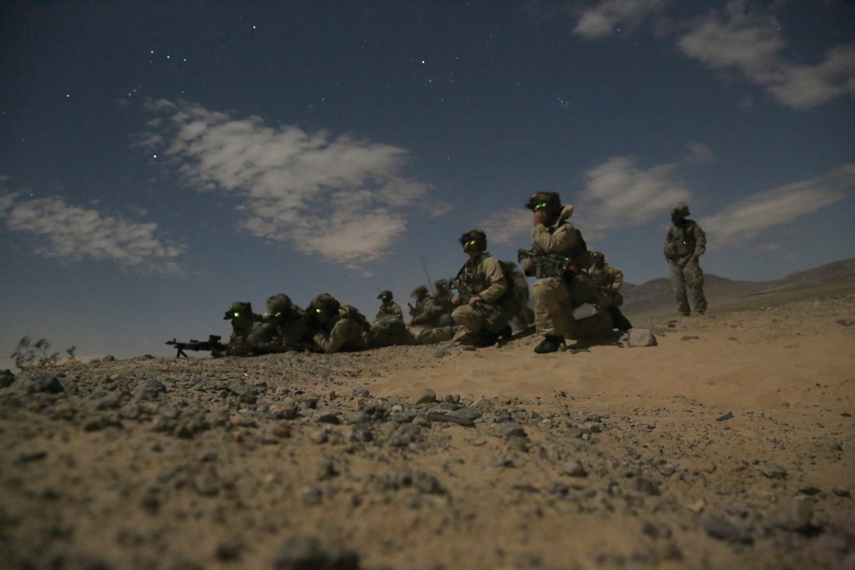 Rangers assigned to Delta Company, 3rd Battalion, 75th Ranger Regiment, overwatch and provide cover for an assault on a night raid during a training exercise at Fort Irwin, California, 24 February 2015