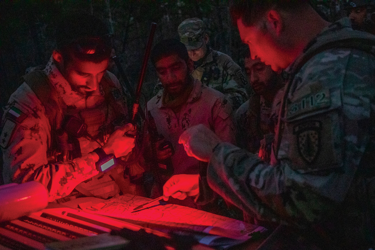 Soldiers from the United Arab Emirates 11th Mountain Battalion and advisors from the U.S. 3rd Security Force Assistance Brigade prepare to conduct a night tactical movement 26 February 2023 during Joint Readiness Training Center Rotation 23-04 on Fort Johnson, Louisiana