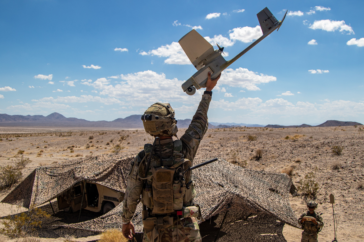 Army advisors assigned to 1st Security Force Assistance Brigade employ an RQ-11B Raven small unmanned aircraft during tactical training at Fort Irwin, California, 17 August 2023. The advisors trained alongside role players and actual partners to prepare for large-scale combat operations