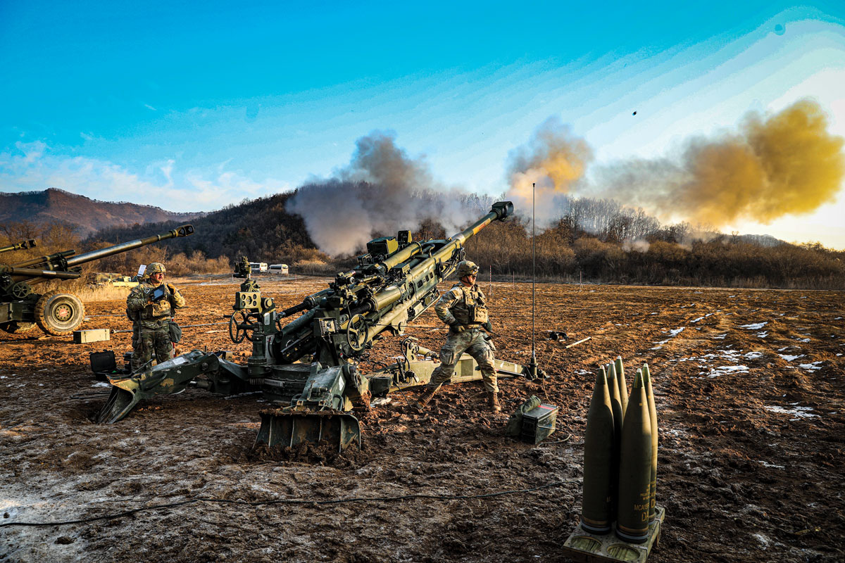 An artilleryman assigned to 2nd Battalion, 17th Field Artillery Regiment, 2nd Stryker Brigade Combat Team, 2nd Infantry Division, fires an M777 howitzer during an artillery training exercise on 12 January 2023 in South Korea during Korea Rotational Force 12
