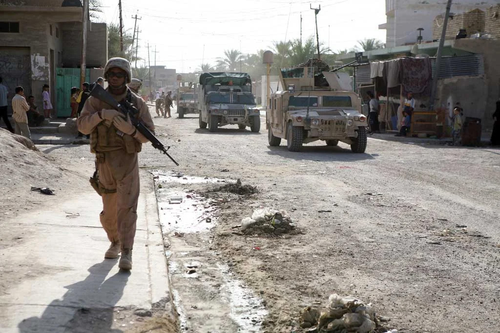 A marine with Regimental Combat Team 6 patrols the streets of Fallujah