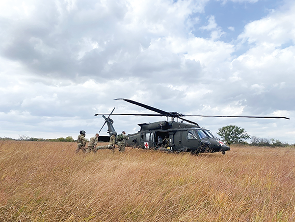 A patient is loaded into a UH-60A Black Hawk medevac aircraft. AI will play an integral role in increasing the accuracy and efficiency of patient movement by reducing the number of pilots and crew required for medevac missions as well as by performing administrative functions and monitoring patients en route