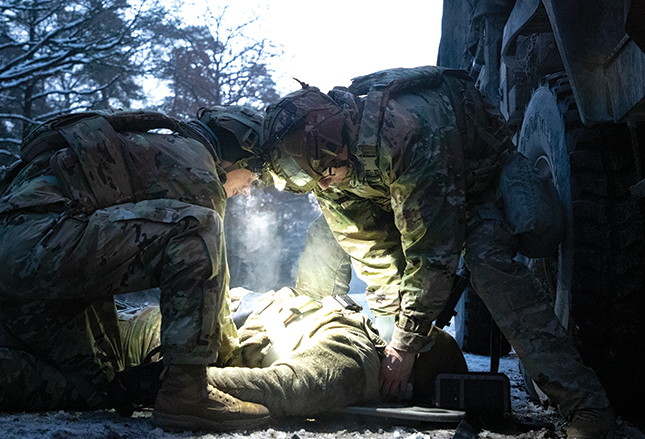 the European Best Medic Competition, and neither Spc. Connor Ignozzi nor Spc. Carl Cleveland assigned to the Headquarters and Headquarters Troop, 1st Squadron, 1st Cavalry Regiment, 2nd Armored Brigade Combat Team, 1st Armored Division, waste any time as they assess a simulated rollover casualty in Grafenwöhr, Germany, on 7 December 2023