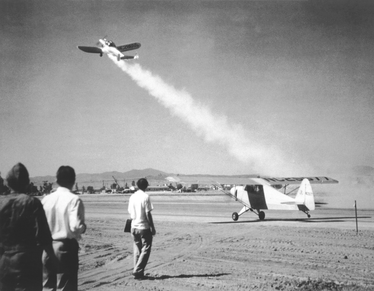A jet-assisted airplane successfully takes off during a test circa August 1941. The airplane on the ground is attempting to take off without rocket assistance.
