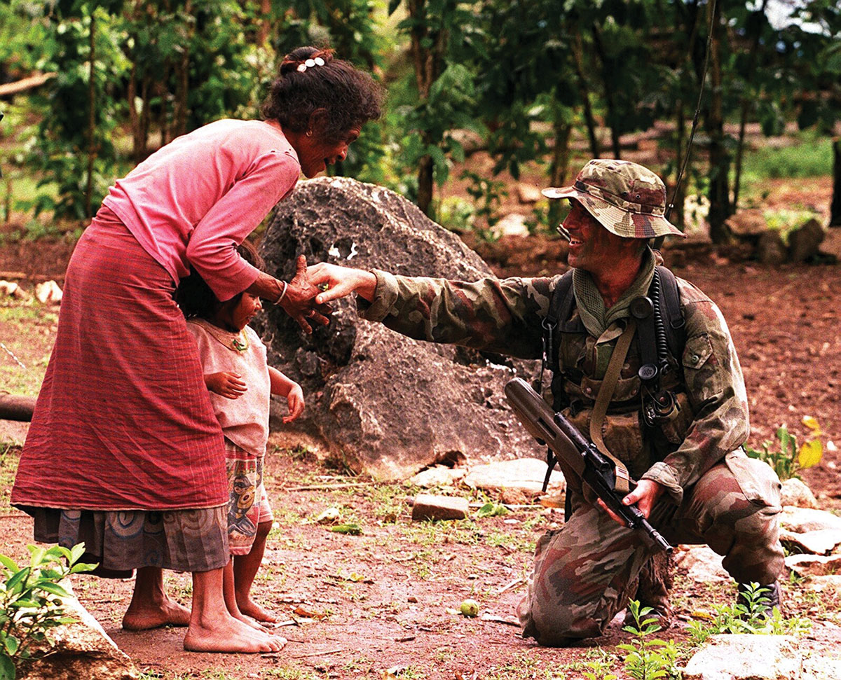 Capt. Jim Deery talks with locals in the village of Fatululic, East Timor