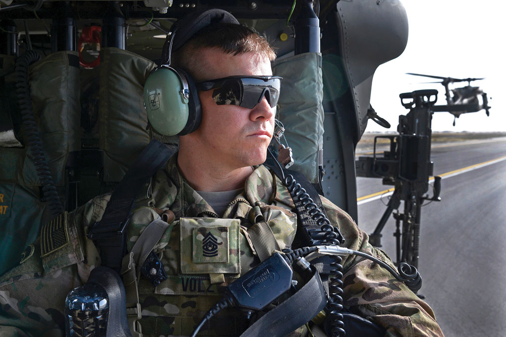 Command Sgt. Maj. Jody Volz, Afghan adviser for Train Advise Assist Command-South, looks out as a U.S. Army UH-60 Black Hawk helicopter lifts off from Kandahar Airfield, Afghanistan, 4 August 2015, to conduct an aerial battlefield familiarization flight