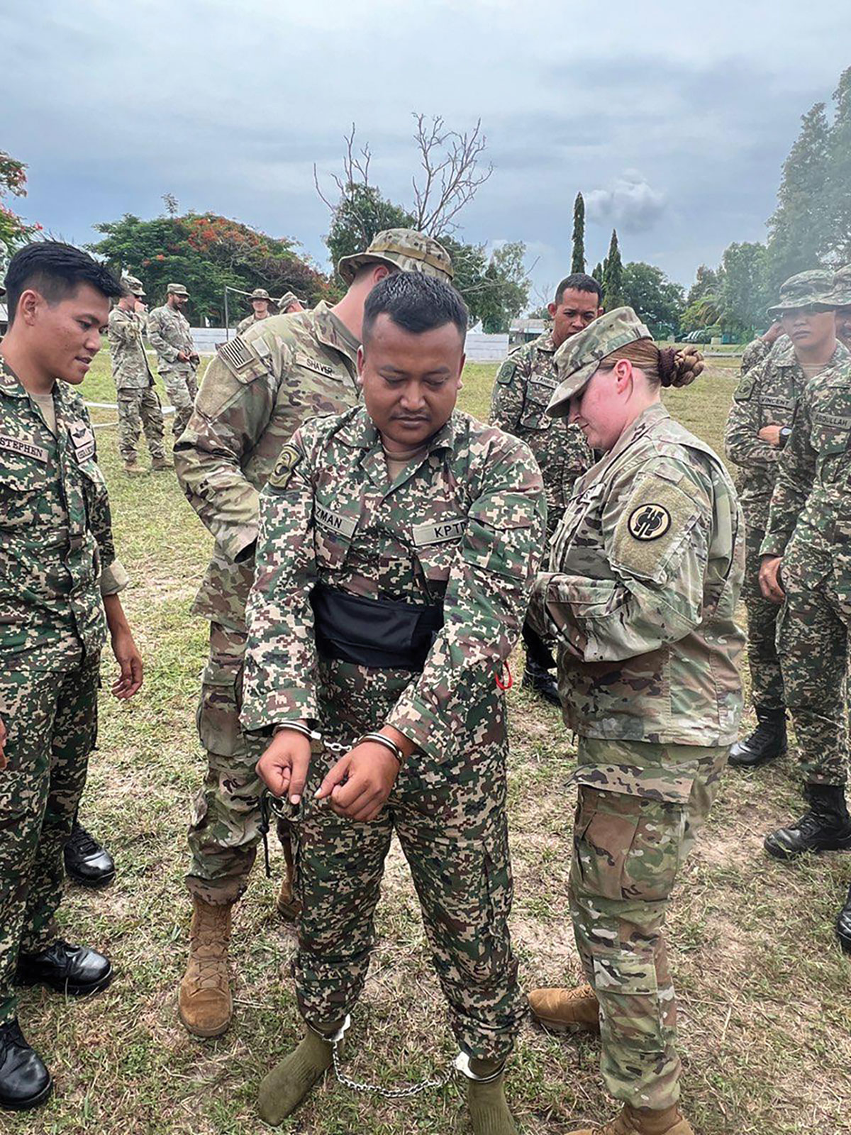 Spcs. Kelly Klarissa and Jedidah Shaver of the 493rd Military Police Company teach a restraints course during the subject-matter expert exchange portion of Keris Strike 2023, 14 July–9 August 2023, in Malaysia