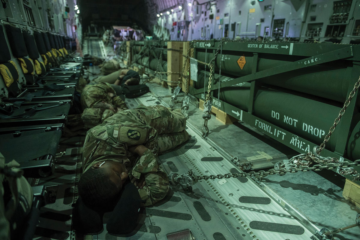 Soldiers sleep on the floor