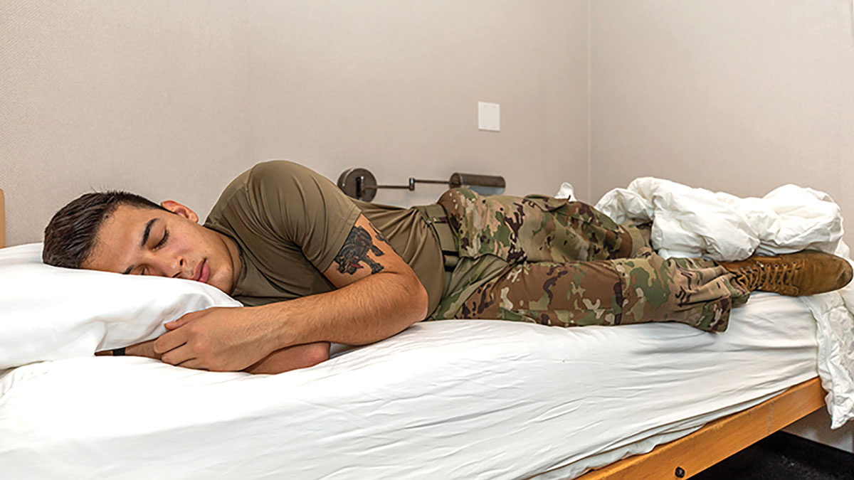 A soldier demonstrates how sleep study suites are used at the Center for Military Psychiatry and Neuroscience