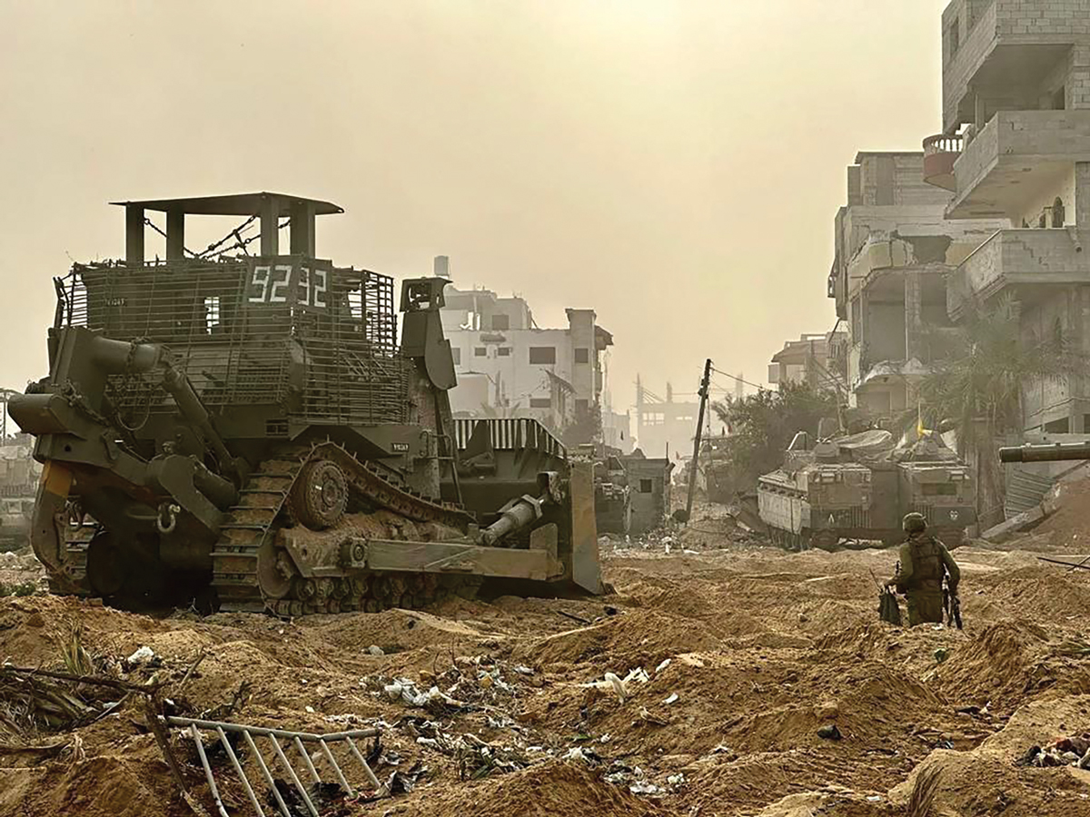 An Israeli armored bulldozer operates inside the Gaza Strip