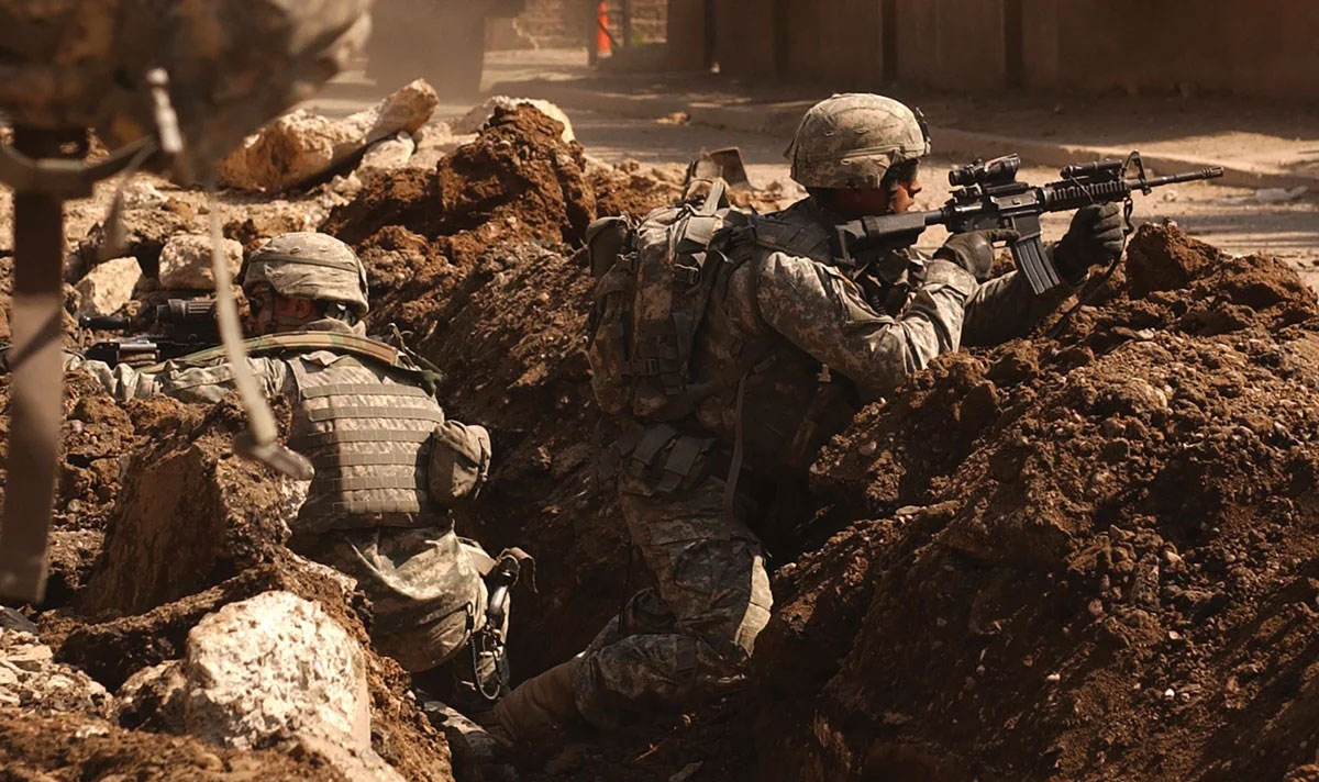 Sgt. Auralie Suarez and Pvt. Brett Mansink take cover in a ditch