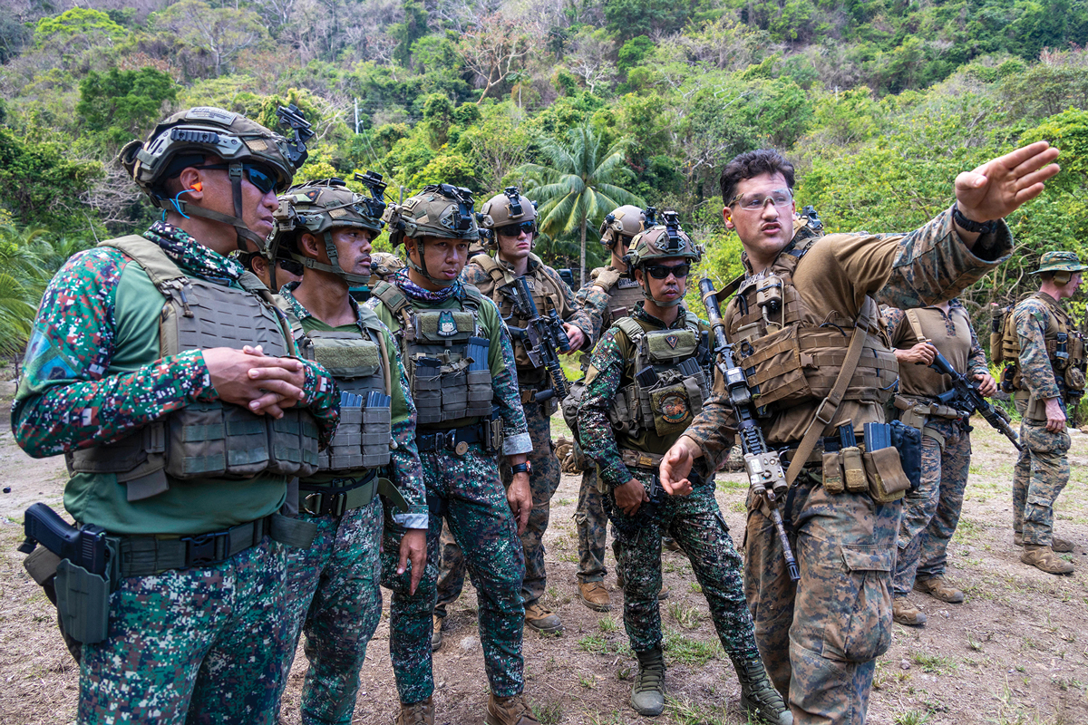 A marine from the 11th Marine Expeditionary Unit confers with marines from the Philippine Reconnaissance Marines 19 April 2023 in preparation for close quarters training during Exercise Balikatan 23 in the Philippines