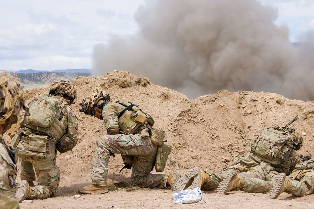 Soldiers assigned to Company C, 4th Battalion, 9th Infantry Regiment, 1st Stryker Brigade Combat Team, 4th Infantry Division, take cover while detonating a claymore mine 5 June 2024, on Fort Carson, Colorado