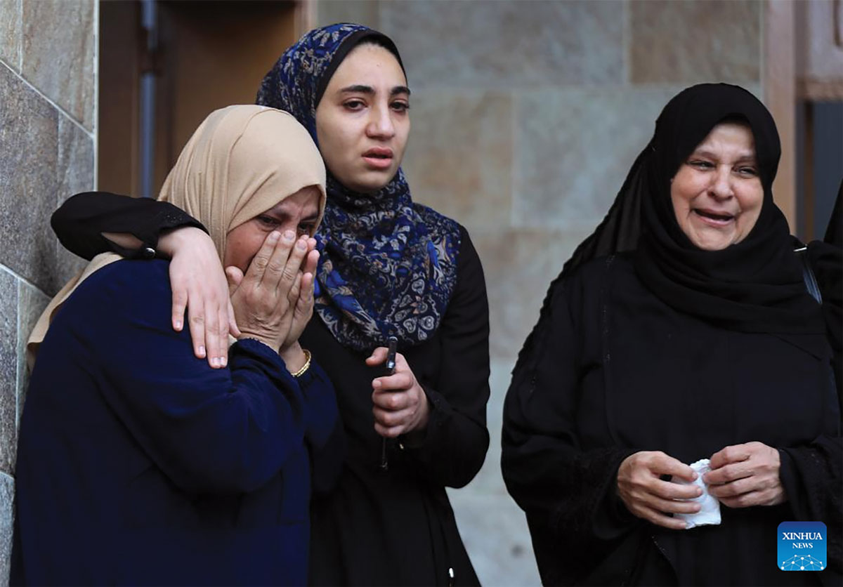 Palestinian women mourn victims killed in the Israel-Hamas conflict