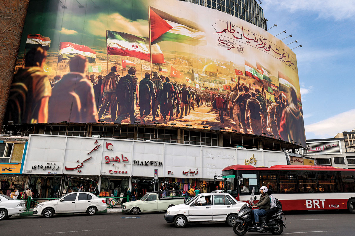 Motorists drive past a giant billboard erected in Valiasr Square in the center of Tehran, Iran