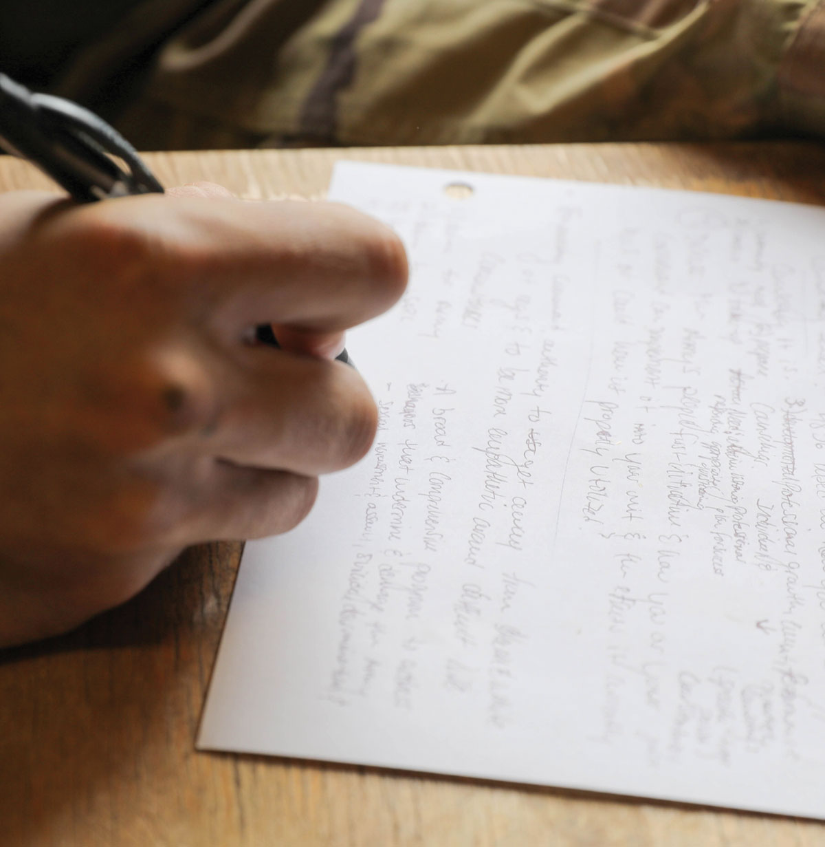 A soldier writes during the essay preparation.