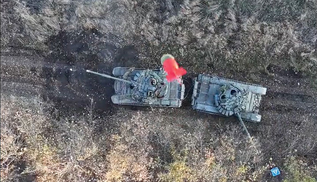 An armed quadcopter drone belonging to the Ukrainian army’s  30th Mechanized Brigade drops a red grenade on a Russian tank attempting a hit-and-run raid on Ukrainian positions north of  Bakhmut in eastern Ukraine in late 2023