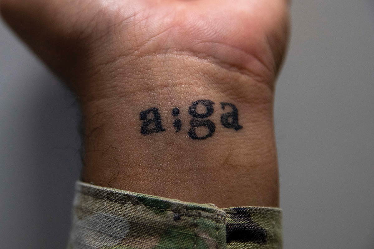 Spc. Matthew Mackintosh, a public affairs specialist with Headquarters and Headquarters Battalion, U.S. Army Pacific, displays a tattoo on his wrist on 2 October 2023 at Fort Shafter, Hawaii.