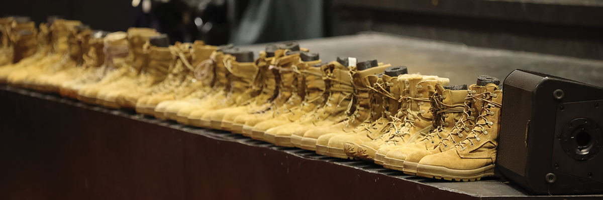 Combat boots line the stage of Beaty Theater, Fort Gregg-Adams, Virginia, on 20 September 2023 
