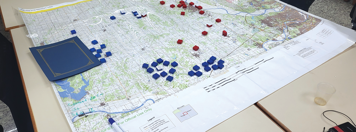 Based on the phase one computer products from the decisive Action simulation software, the students continued the wargaming exercise using the map-based Land Power analog simulation