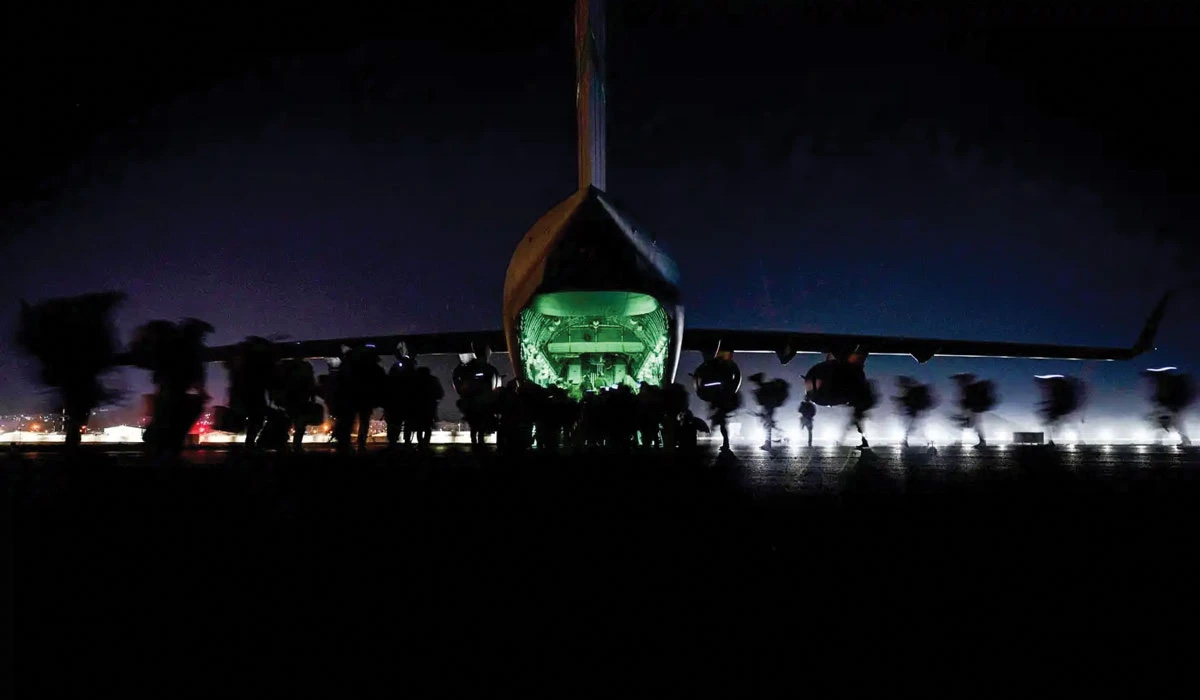 Soldiers assigned to the 82nd Airborne Division prepare to board a U.S. Air Force C-17 Globemaster III aircraft in support of the final noncombatant evacuation operation (NEO) missions at Hamid Karzai International Airport, Afghanistan, 30 August 2021. The Afghanistan NEO was the largest noncombatant evacuation operation ever conducted by the U.S. military.