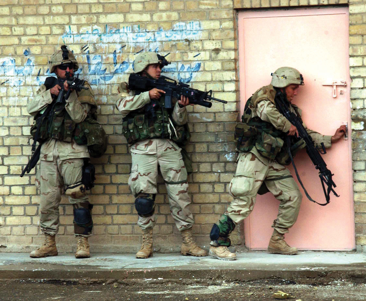 Soldiers from the 1st Cavalry Division prepare to enter and clear a building 12 November 2004 during fighting in Fallujah