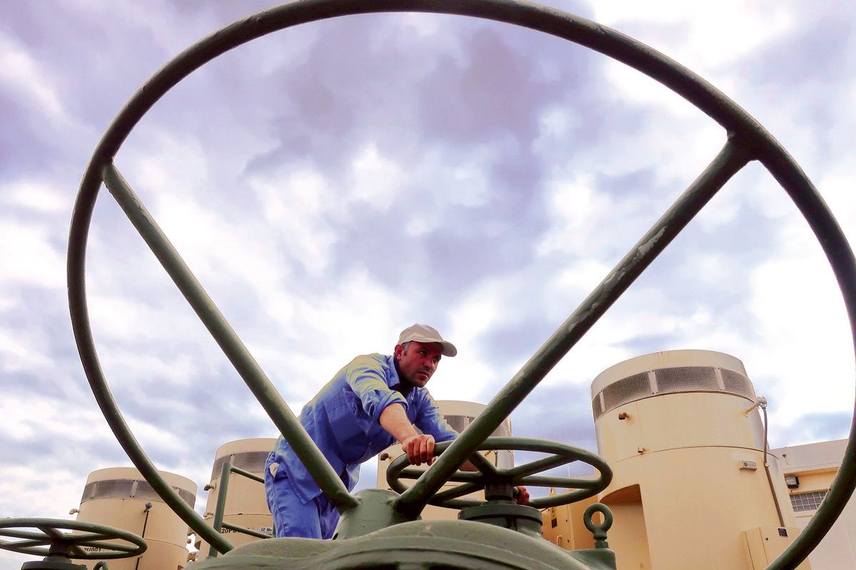 An Ifras Water Center technician adjusting the water intake settings.