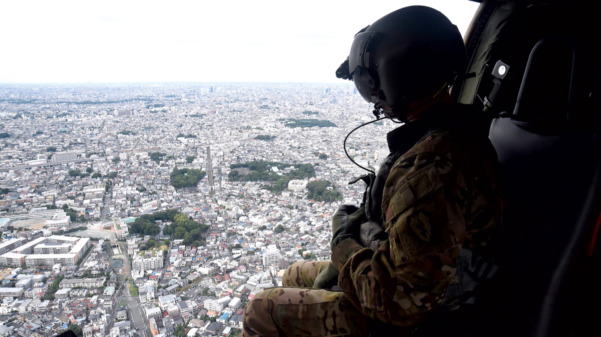 A photo of Sgt. Marshall Medley overlooking Tokyo from a helicpoter flying above.