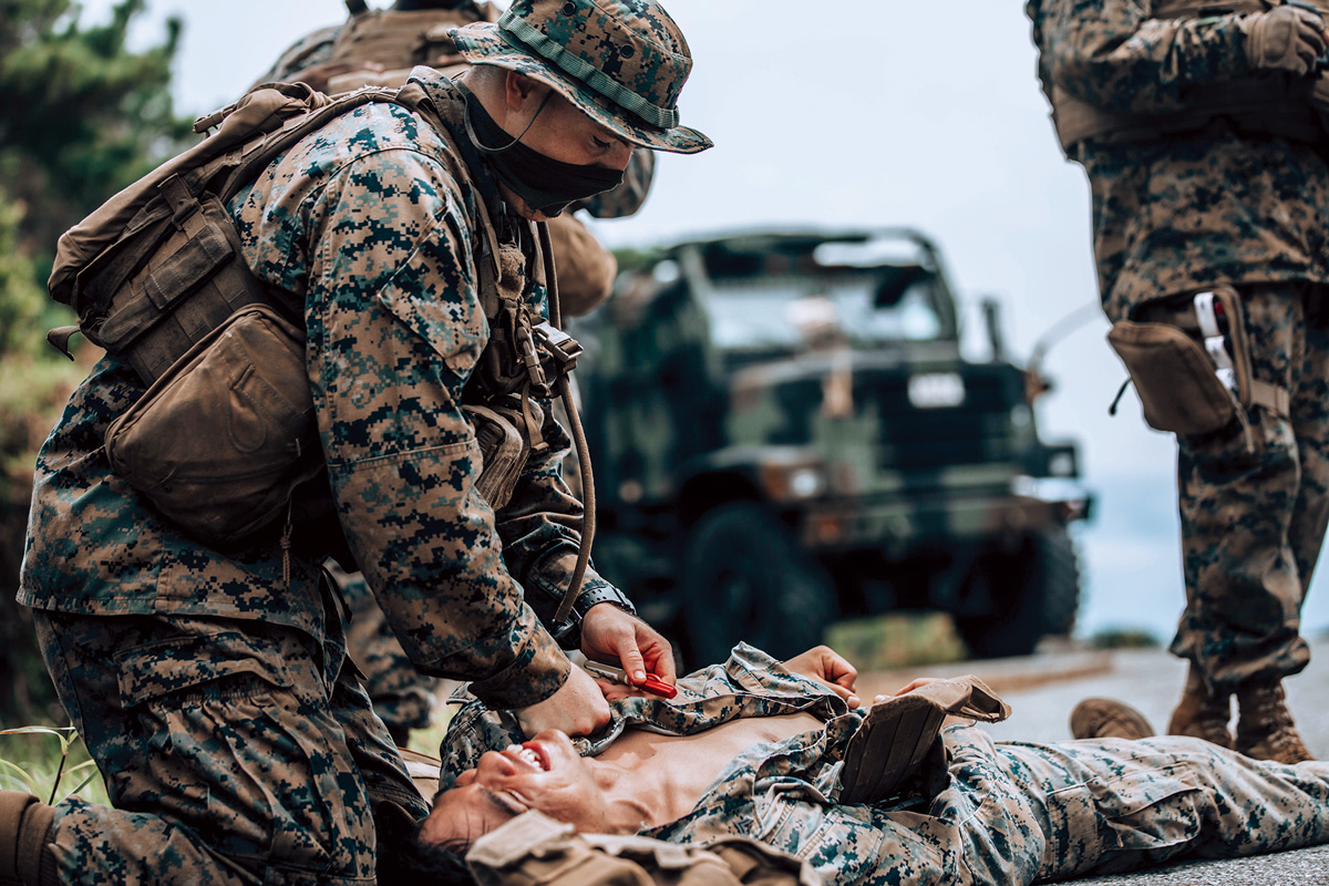 A photo of soldiers demostrating the proper procedures for Tactical Combat Casualty Care