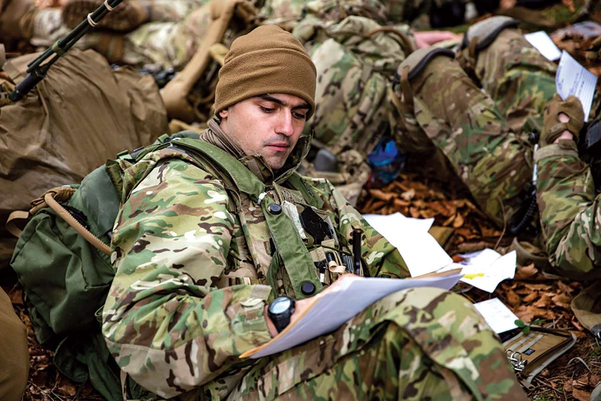 A photo of a paratrooper sitting on the ground