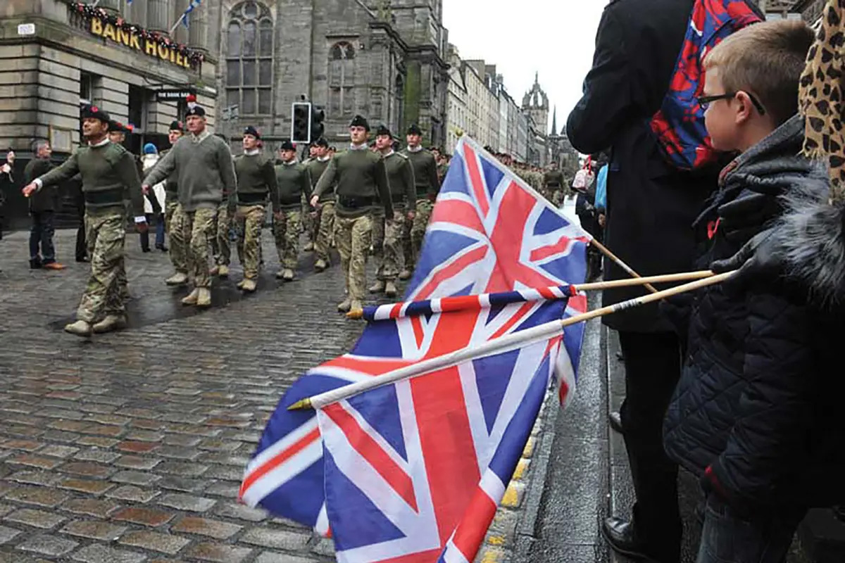 Crowds line the streets of Edinburgh, Scotland, as soldiers of 3rd Battalion, 3 RIFLES, march through the city 3 November 2012 after returning from a demanding six-month tour in Helmand Province during Operation Herrick 16 as part of the 12th Mechanized Brigade.