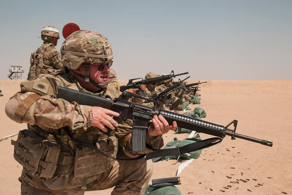 California Army National Guard Staff Sgt. Donald Dow, a chaplain’s assistant with the 40th Combat Aviation Brigade, fires his M-16A2 at a rifle qualification range near Camp Buehring, Kuwait, 5 April 2016. One of the duties of the chaplain’s assistant is to protect the chaplain during combat because chaplains are prohibited by regulation from carrying weapons