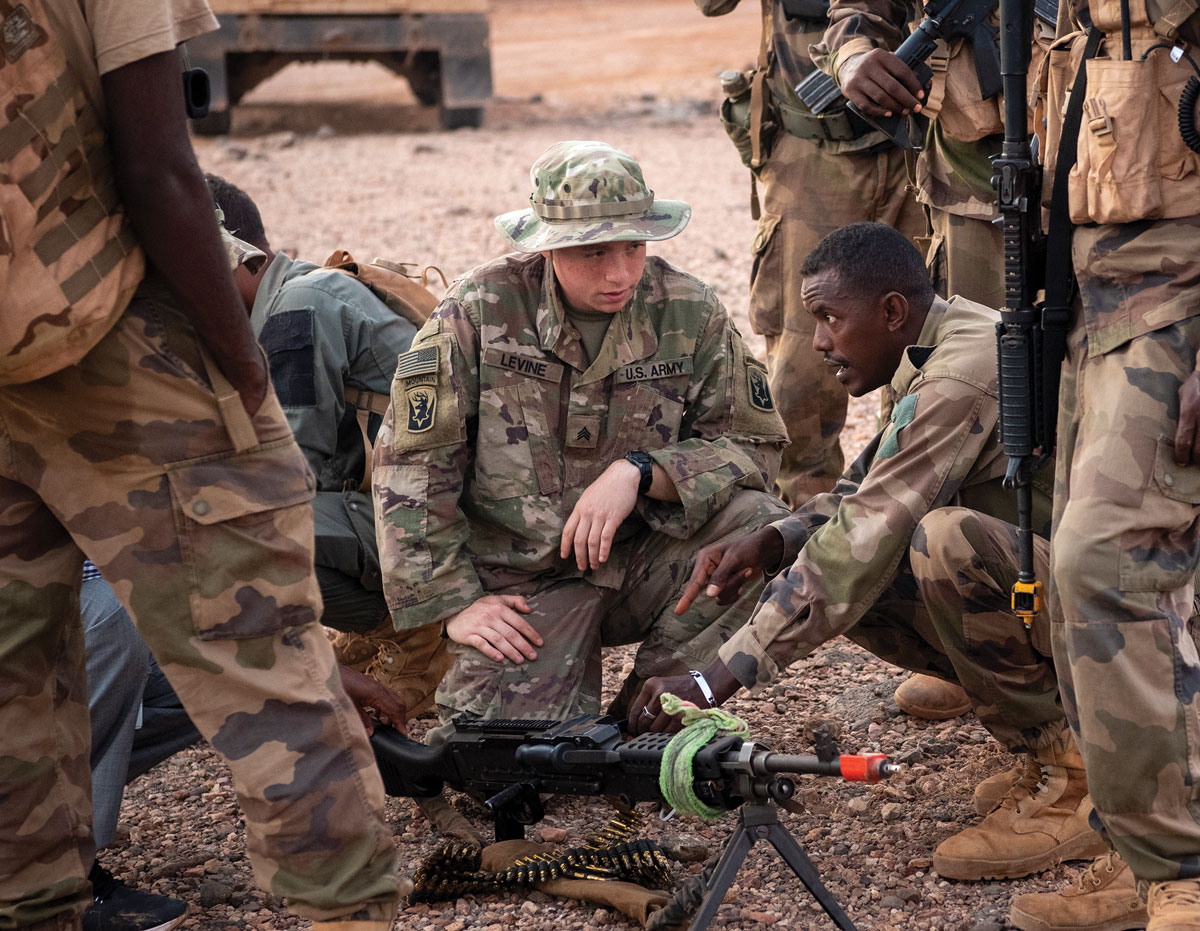 Soldados de EUA y Yibuti discuten las capacidades de una ametralladora M240B como parte de la misión de asistencia de fuerzas de seguridad en el extranjero en 2021.