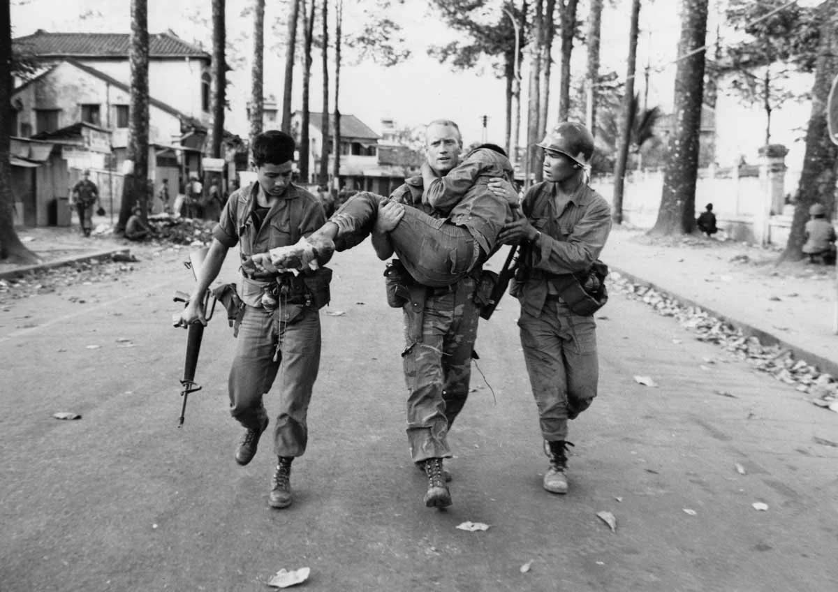 El teniente primero Gary D. Jackson lleva a un soldado survietnamita herido a una ambulancia tras una breve pero intensa batalla con el Viet Cong durante la Ofensiva del Tet el 6 de febrero de 1968 cerca del Estadio Deportivo Nacional en la sección Cholon de Saigón