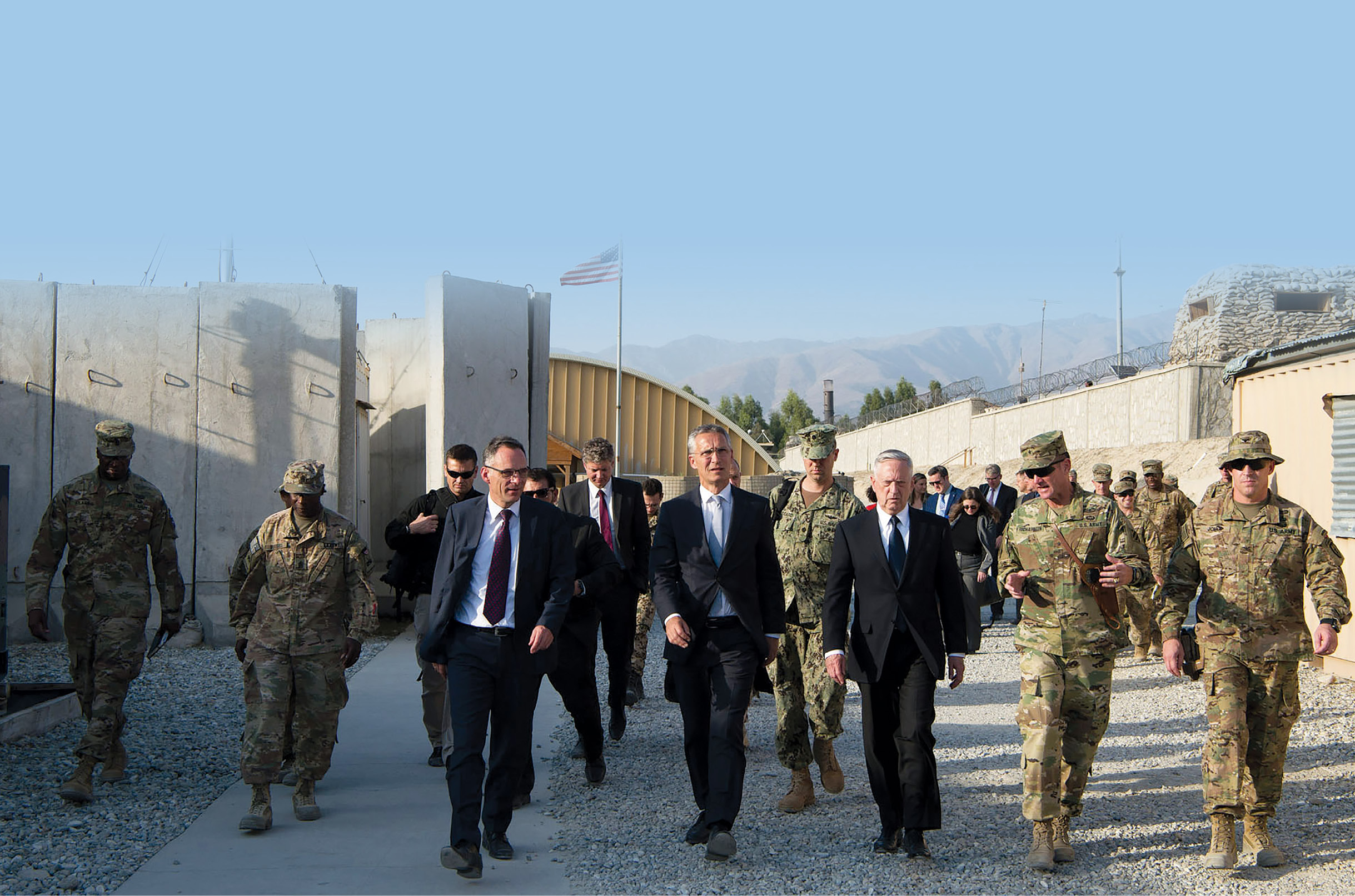 U.S. Secretary of Defense Jim Mattis (third from right) and NATO Secretary General Jens Stoltenberg (fourth from right) walk to a meeting 27 September 2017 with deployed forces in Afghanistan. (Photo by Staff Sgt. Jette Carr, U.S. Air Force)