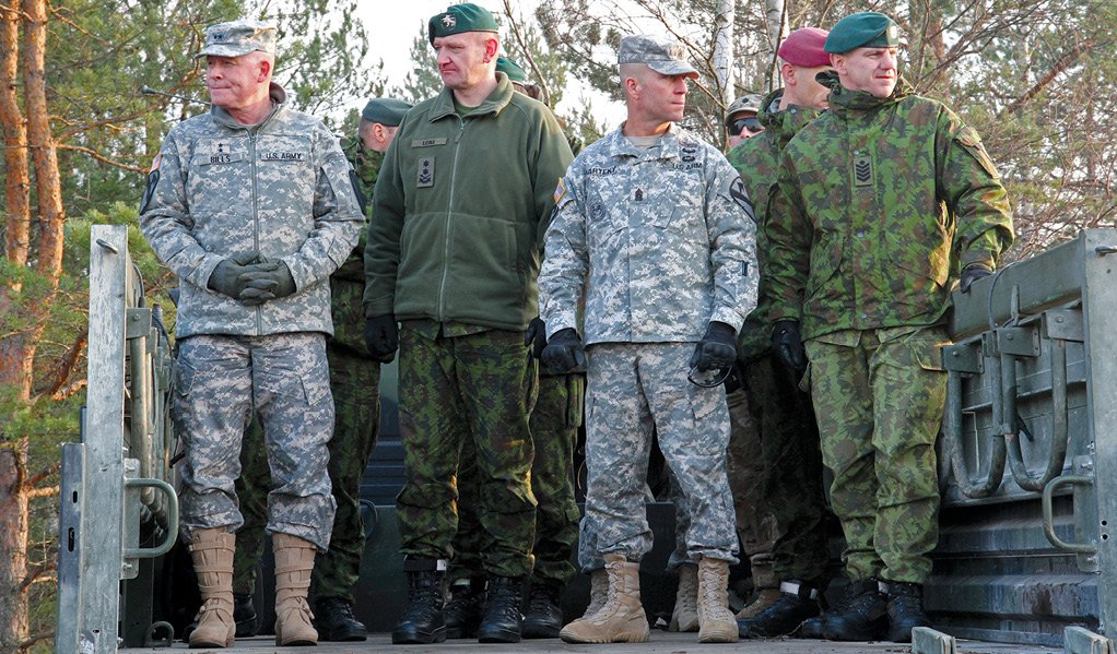 Maj. Gen. Michael A. Bills, 1st Cavalry Division commander (left), and Command Sgt. Maj. Andrew L. Barteky, 1st Cav. Div. (second from right), stand beside their Lithuanian counterparts, Maj. Gen. Almantas Leika, Land Forces commander (second from left), and Command Sgt. Maj. Osvaldas Žurauskas (right), to observe a combined arms live-fire exercise 30 October 2014 at a firing range near Pabrade, Lithuania. These activities were part of the U.S. Army Europe-led Operation Atlantic Resolve land force assurance training that took place across Estonia, Latvia, Lithuania, and Poland to enhance multinational interoperability, strengthen relationships among allied militaries, contribute to regional stability, and demonstrate U.S. commitment to NATO. (Photo by Spc. Seth LaCount, U.S. Army National Guard)