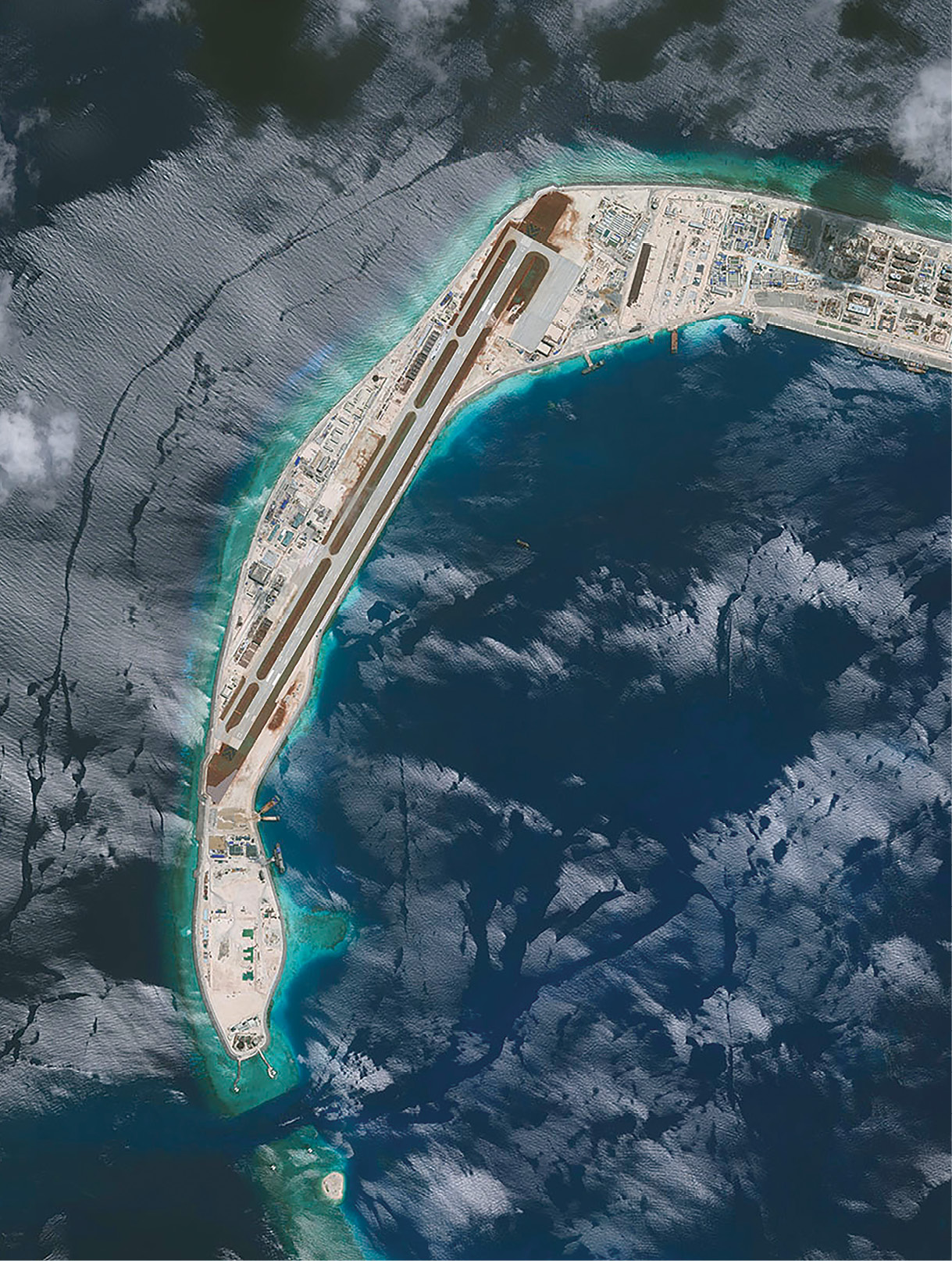 A 2.6-kilometer runway is clearly identifiable in this 22 July 2016 satellite photo of the western arm of Mischief Reef, located east of the contested Spratly Islands in the South China Sea. The reef is one of several that have been occupied by Chinese forces in recent years as part of that country’s land reclamation efforts, undertaken to gain and control access to the South China Sea. (Photo courtesy of the Center for Strategic and International Studies/Asia Maritime Transparency Intitiative/DigitalGlobe)