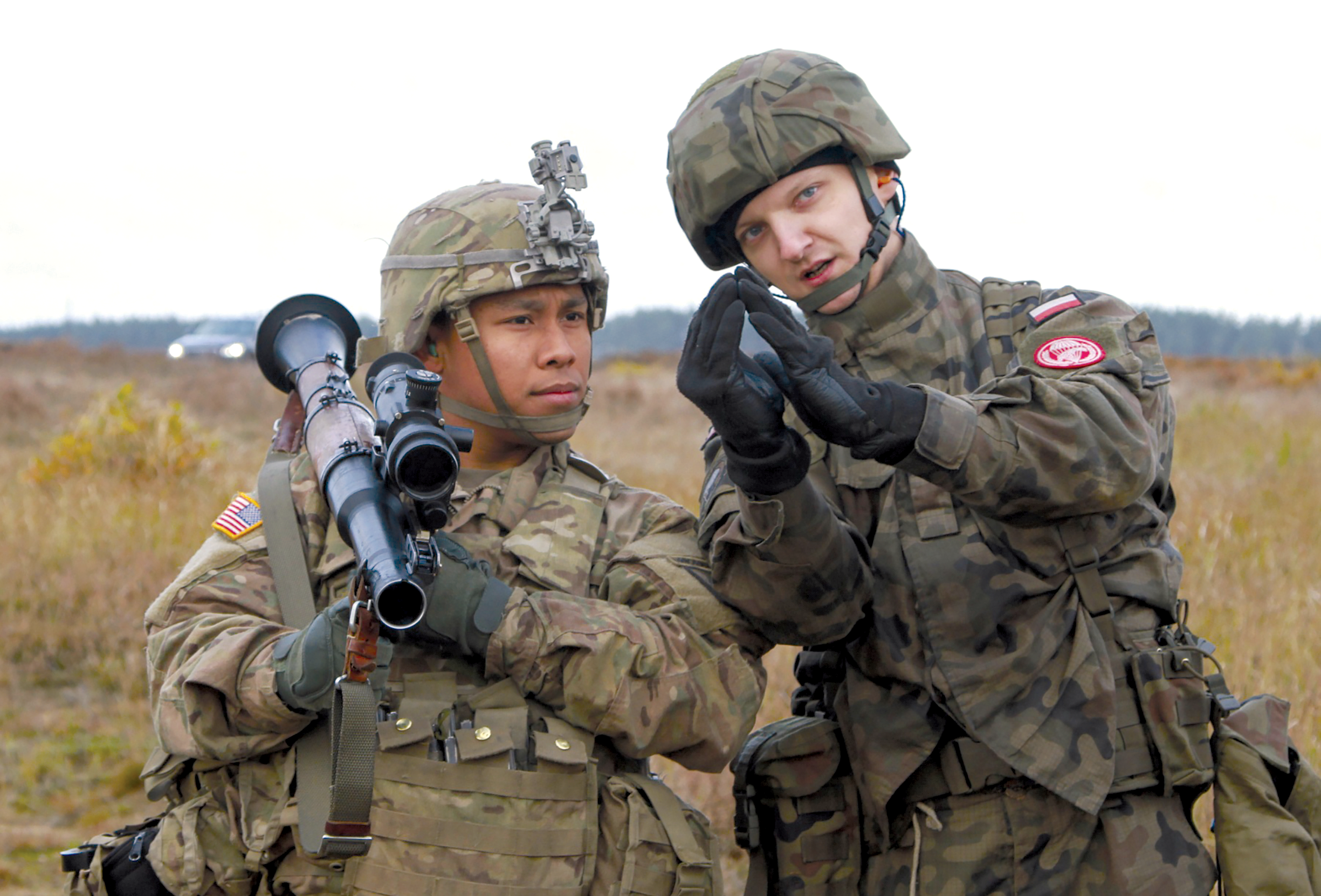 Spc. Jacob Quitugua, 2nd Battalion, 503rd Infantry Regiment, 173rd Airborne Brigade, holds an RPG-7D antitank grenade launcher while Pvt. Pawel Tylek, 16th Polish Airborne Battalion, 6th Airborne Brigade, describes the proper sight picture for the weapon 29 October 2016 during antiarmor training in Studnica, Poland. The U.S. soldiers were in Poland on a training rotation in support of Operation Atlantic Resolve, a U.S.-led effort in eastern Europe that demonstrates U.S. commitment to the collective security of NATO and dedication to enduring peace and stability in the region.  (Photo by Sgt. Lauren Harrah, U.S. Army)