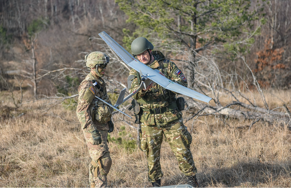 A paratrooper with 1st Squadron, 91st Cavalry Regiment, 173rd Airborne Brigade and a Slovenian soldier assemble and launch an RQ-11B Raven unmanned aerial vehicle 1 December 2016 during Exercise Mountain Shock in Cerklje, Slovenia. The drill was part of a situational training exercise designed to train and test their reaction to contact and tactical battle drills. (Photo by Staff Sgt. Philip Steiner, U.S. Army)