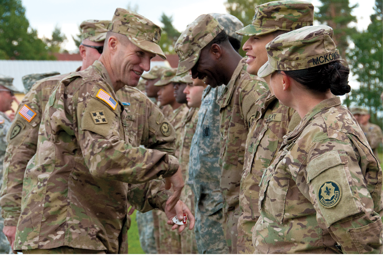 Sgt. Maj. of the Army Daniel A. Dailey jokes with 2nd Cavalry Regiment soldiers 9 September 2015 as he presents them with command excellence coins during a visit to Rose Barracks in Vilseck, Germany. Dailey remains popular with troops because he listens to their concerns and acts to resolve them. (Photo by Staff Sgt. Jennifer Bunn, U.S. Army)