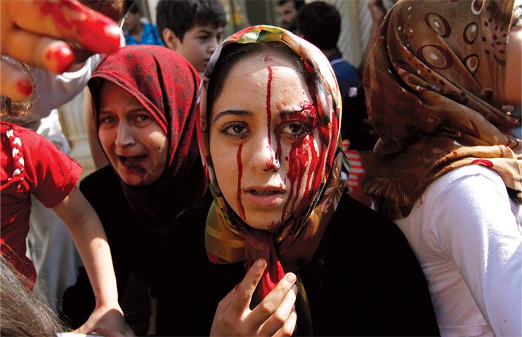 Injured Syrian women arrive at a field hospital 15 August 2012 after an air strike hit their homes in the town of Azaz on the outskirts of Aleppo, Syria. (Photo by Khalil Hamra, Associated Press)