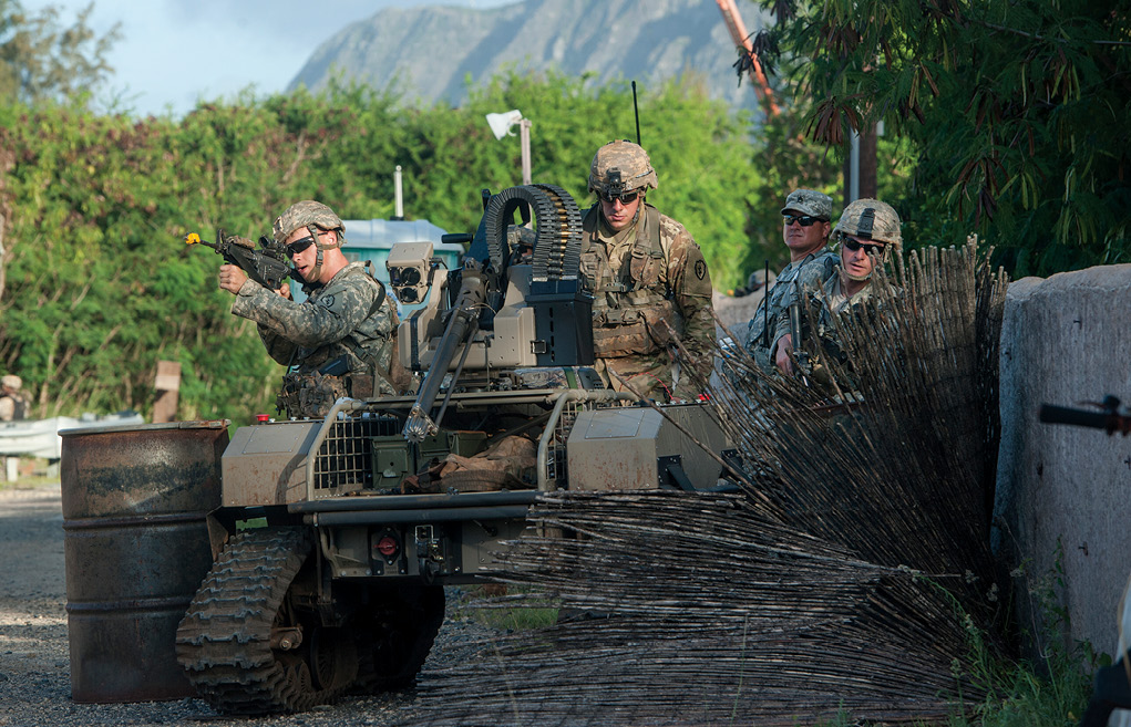 Soldiers from 2nd Battalion, 27th Infantry Regiment, 3rd Brigade Combat Team, 25th Infantry Division, move forward toward simulated opposing forces with a multipurpose unmanned tactical transport 22 July 2016 during the Pacific Manned-Unmanned Initiative at Marine Corps Training Area Bellows, Hawaii. (Photo by Staff Sgt. Christopher Hubenthal, U.S. Air Force)