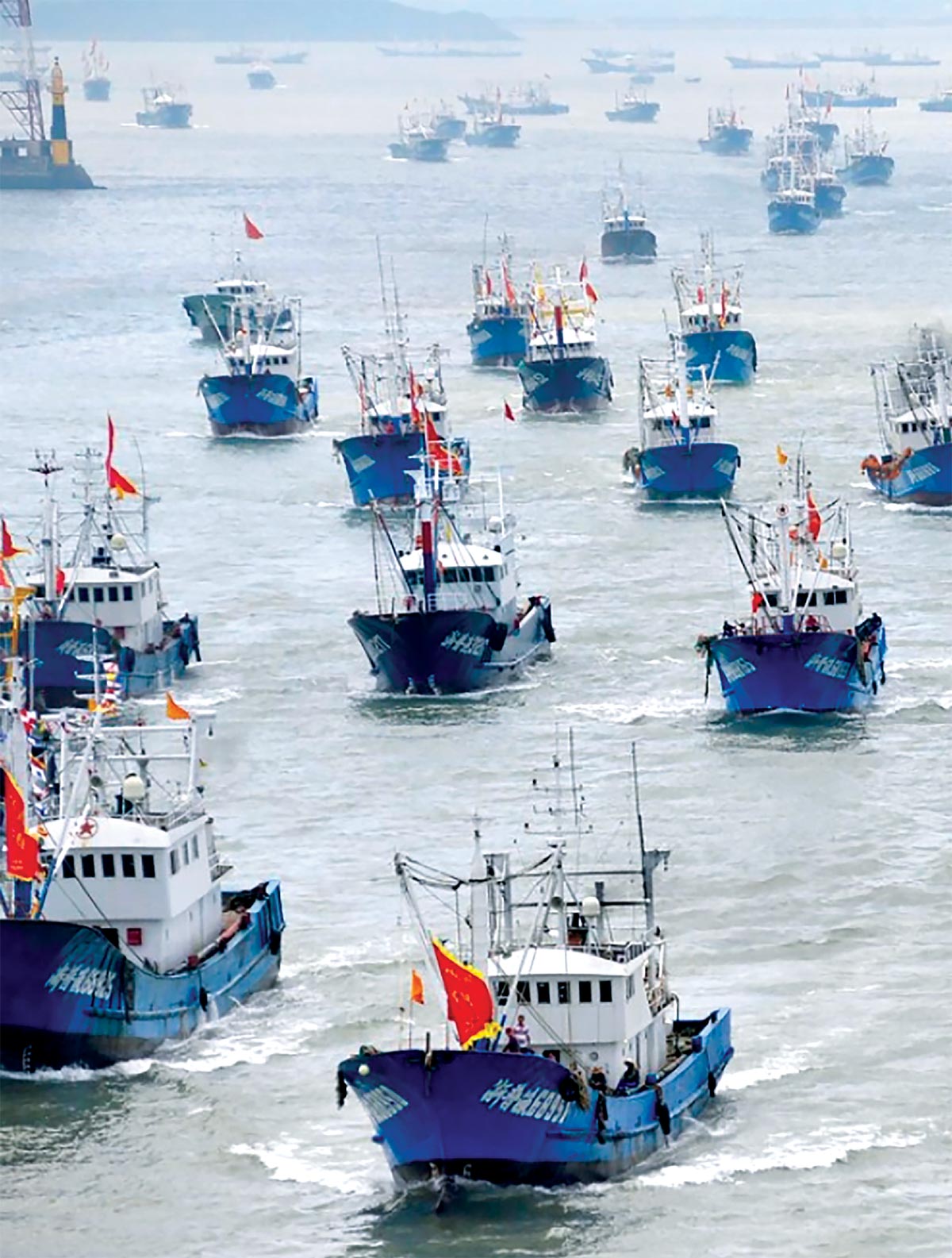 Chinese fishing boats head out to sea from Zhoushan in Zhejiang Province, China. (Photo courtesy of China Foto Press)