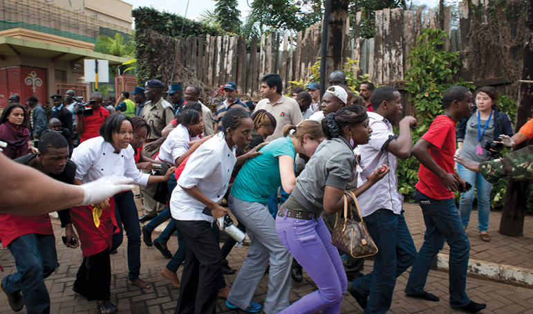 People flee from gunfire and grenade blasts 21 September 2013 during a terrorist attack at the Westgate Mall in Nairobi, Kenya.