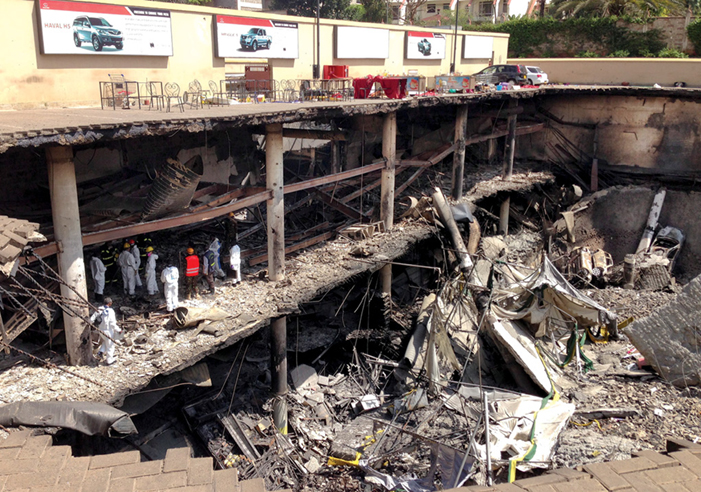 Forensics investigators work next to the collapsed upper car park at the Westgate Mall 1 October 2013 in Nairobi, Kenya.