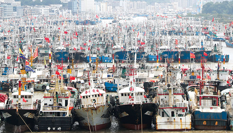 An aerial view of thousands of fishing boats as they berth near Shenjiamen Harbor 1 September 2020 due to Typhoon Maysak, the ninth typhoon of the year in Zhoushan City, east China’s Zhejiang Province. (Photo by Imaginechina via Associated Press)