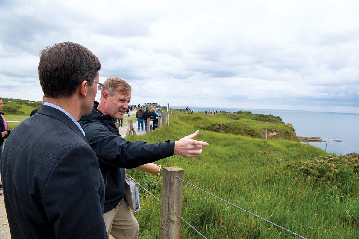 Dr. Peter Knight, U.S. Army Center of Military History Field Programs Directorate, describes the action at Pointe du Hoc, Normandy, France, on the anniversary of D-Day 5 June 2019 for Secretary of Defense Mark Esper during the seventy-fifth anniversary celebration.