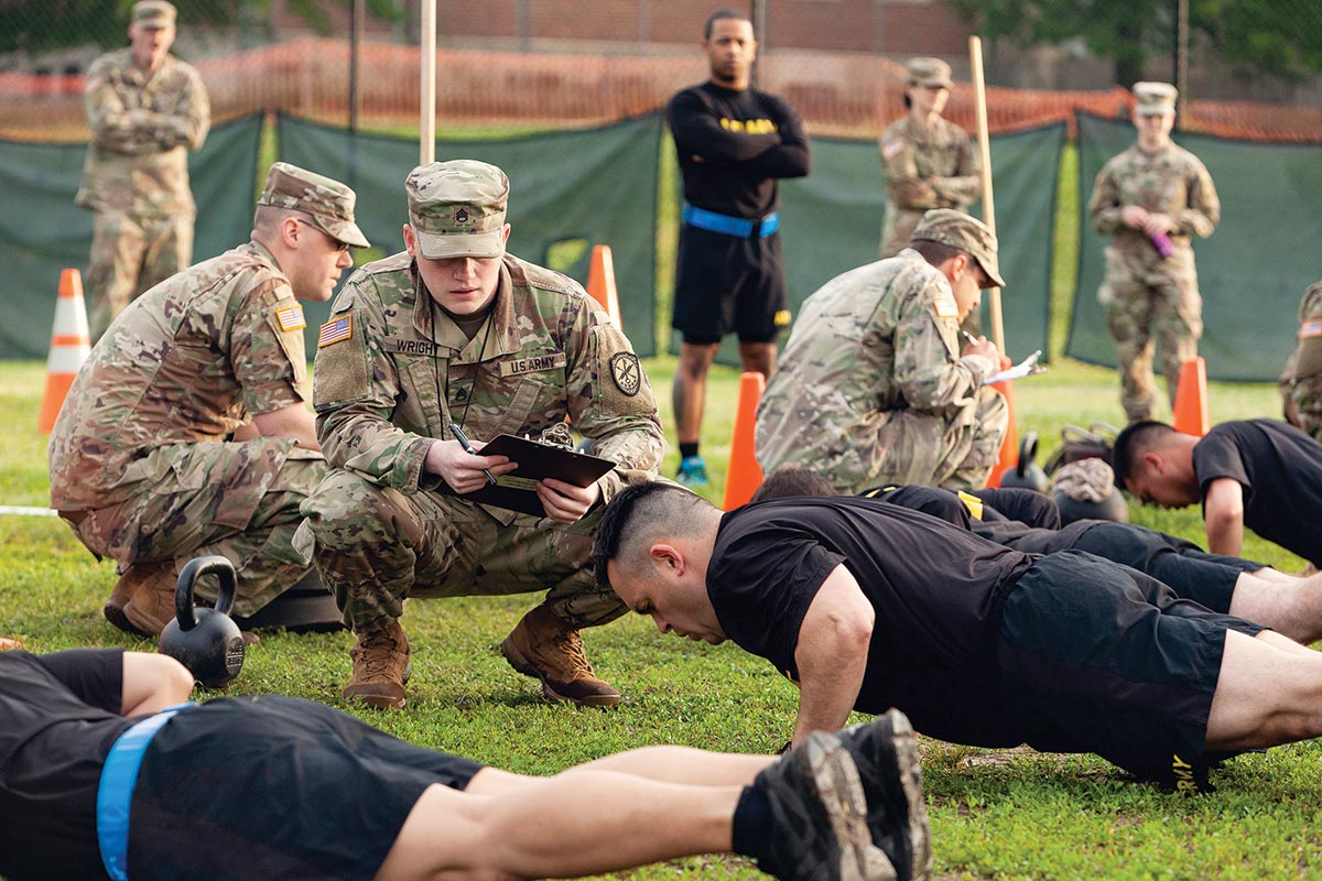 Staff Sgt. Gabriel Wright, a signals intelligence analyst with the 780th Military Intelligence Brigade, grades the hand-release push-up event 17 May 2019 as part of Army Combat Fitness Test Level II grader validation training at Fort George G. Meade, Maryland.