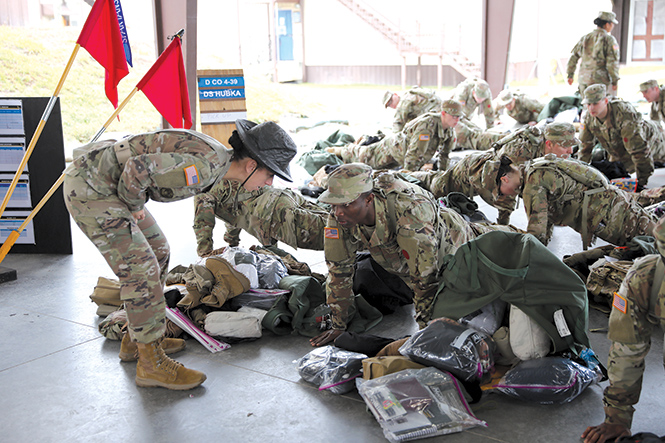 Sgt. 1st Class Lisa Capocci, a U.S. Army Reserve drill sergeant from the 98th Training Division, explains something to a trainee 18 November 2019 during the Pick-Up Day process at Fort Jackson, South Carolina.