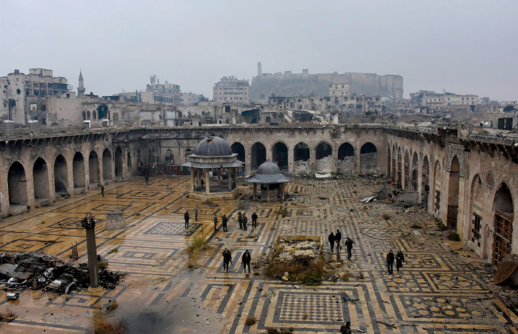 Syrian troops and pro-government gunmen walk inside the destroyed Umayyad Mosque 13 December 2016 in Aleppo, Syria. (Photo courtesy of Syrian Arab News Agency)